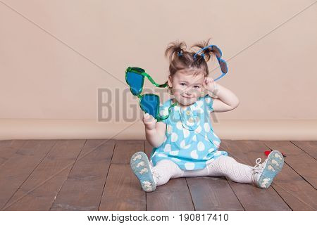 Little Girl Plays With Big Glasses, She Is Funny