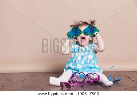 Little Girl Plays With Big Glasses, She Is Funny