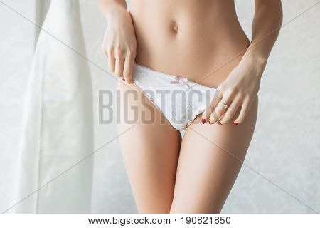 Female butt, white background. Beautiful female butt in a Thong