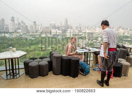 BANGKOK, THAILAND - FEBRUARY 24, 206 : Roof top bar overlooking Lumpini park in Bangkok. Roof top bars are a major tourist attraction in Bangkok.