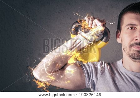 Male athlete lifting kettle bell. Fire illustration.