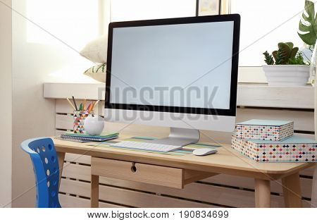 Creative workplace with monitor near windowsill in modern room