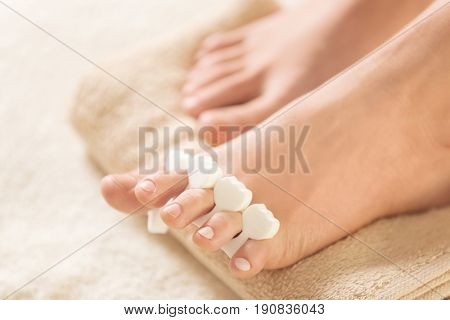 Female legs in pedicure salon