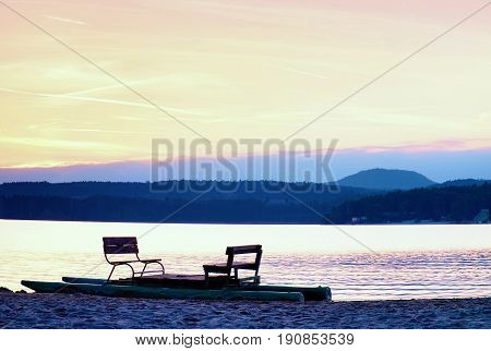 Abandoned Old Rusty Pedal Boat Stuck On Sand Of Beach. Wavy Water Level, Island On Horizon. Autumn S