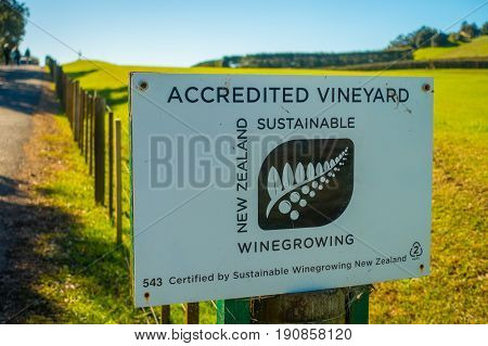 AUCKLAND, NEW ZEALAND- MAY 12, 2017: New Zealand wooden sign with winery background.