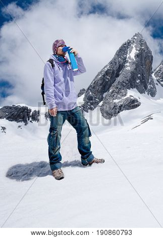 Climber Breathing With Mini Portable Oxygen To Avoid And Treat Altitude Sickness