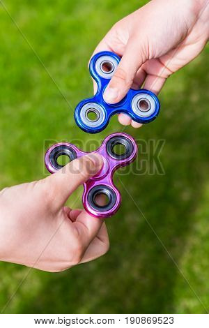 Kid hands with popular toy fidget spinners