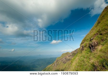Mountain grass and blue skytop of green hill