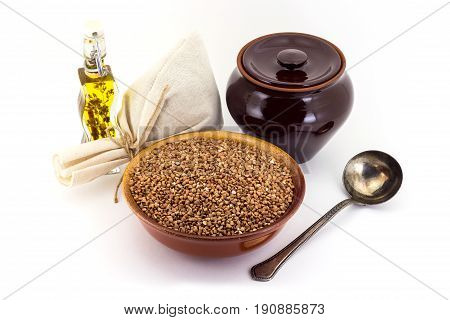 The Composition Of The Buckwheat Groats In A Clay Pial Next To A Clay Pot And A Copper Spoon,