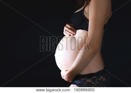 Portrait Of Beautiful Pregnant Woman, Isolated On Black Studio Background