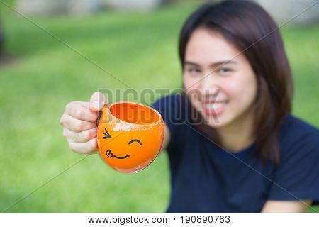 Happy Drink Concept, Asian Teen Handle Smile Mug In The Park.