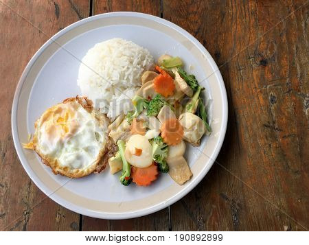 Mixed Fried Vegetable Tofu With Rice And Fried Egg In White Dish On Wooden Background. Vegetarian Fo