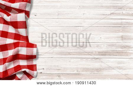 red checkered picnic tablecloth on white wood table