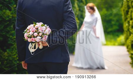 Beautiful bouquet of fresh flowers in hand of Bridegroome