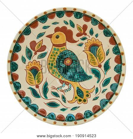 Covered with glaze ceramic plate handmade. Drawing on a plate - the cock. Painting in the technique Kosovo ceramics - it really authentic Ukrainian technique of painting on clay. Isolated on a white background