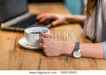 Young Woman Drinking Coffee And Working At Home