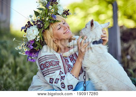 Funny picture a beautiful young girl farmer with a wreath on her
