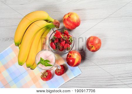 Strawberry Yogurt In A Glass With Fresh Strawberries, Nectarine, Banana On A Wooden Table