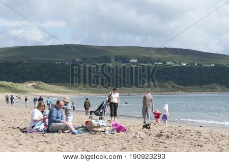 Oxwich beach, Wales, 14-08-2010: A bunch of people all relaxing on the beach in Wales.