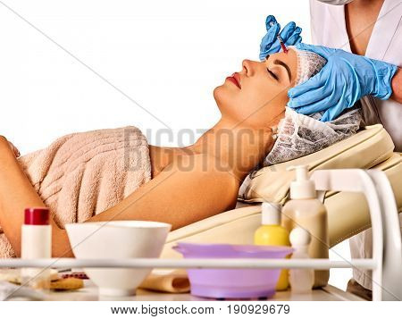 Filler injection for female forehead face. Plastic aesthetic facial surgery by doctor in beauty clinic. Beauty woman giving njections. Doctor in medical gloves with syringe.