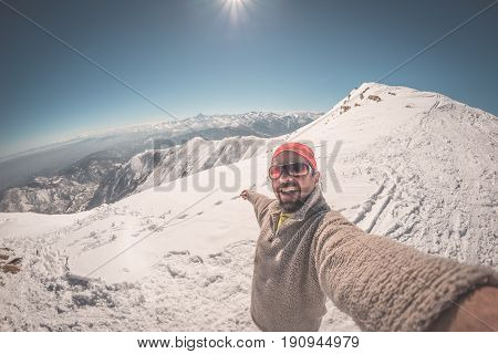 Adult Alpin Skier With Beard, Sunglasses And Hat, Taking Selfie On Snowy Slope In The Beautiful Ital