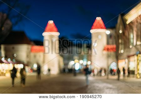 Tallinn, Estonia. Abstract Natural Blurred Boke Bokeh Background Of Landmark Viru Gate In Lighting At Evening Night Illumination. Christmas Xmas New Year Holiday Vacation In Old Town