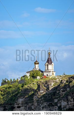 Wonderful landscape with rocks and mountains at orheiul vechi monastery and memorial in moldova, near raut river, blue sky, sunny day, bell tower