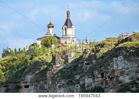 Wonderful landscape with rocks and mountains at orheiul vechi monastery and memorial in moldova, near raut river, blue sky, sunny day, bell tower