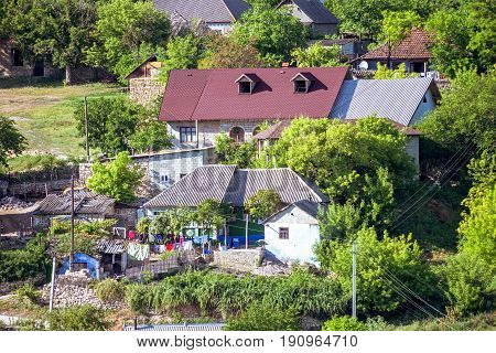 Local house with clothes drying outsite on wires, in Trebujeni village, Orheiul Vechi, Moldova, sunny day