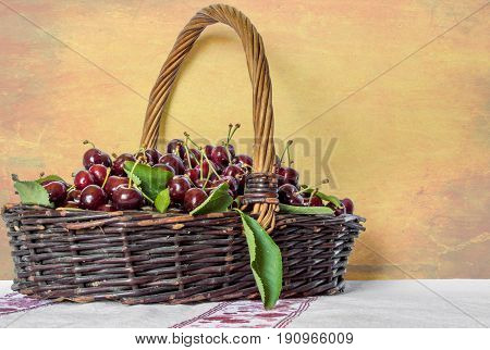Basket of cherries on a vintage background
