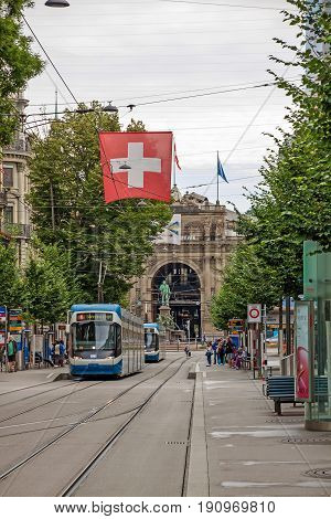 Zurich Shopping Street Bahnhofstrasse With Tram And Swiss Flag