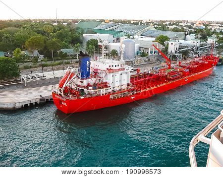 La Romana, Dominican Republic - February 05, 2013: The cargo ship docked in the port in bay at La Romana, Dominican Republic on February 05, 2013. View from cruise ship Costa Luminosa
