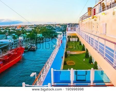 La Romana, Dominican Republic - February 05, 2013: The cargo ship docked in the port in bay at La Romana, Dominican Republic on February 05, 2013. View from cruise ship Costa Luminosa. Costa Luminosa cruise ship, owned and operated by Costa Crociere, buil