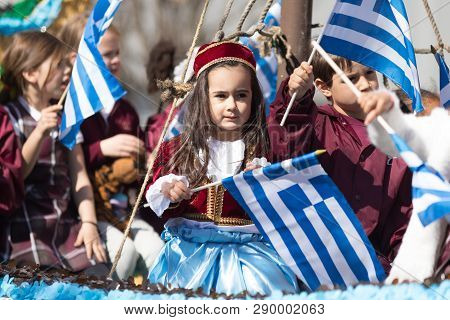 Chicago, Illinois, USA - April 29, 2018  Children wearing traditional clothing waving the greek flag at the Greek Independence  Day Parade