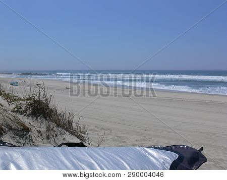 Surfboard In Front Of Breath-taking Backdrop Beach