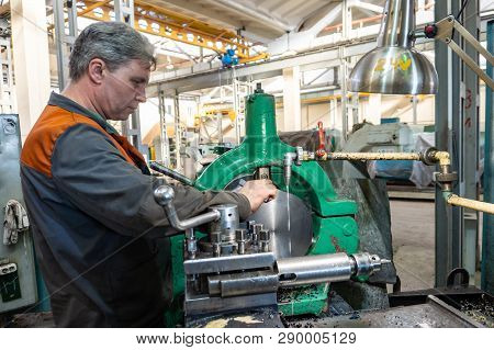 Turner Worker Manages The Metalworking Process Of Mechanical Cutting On A Lathe