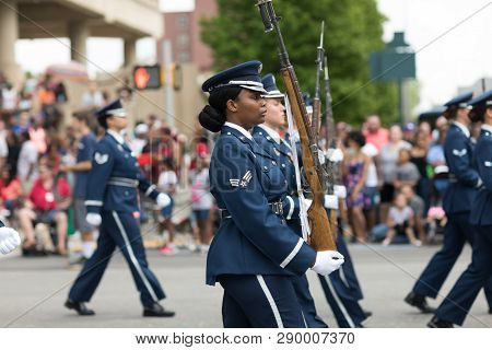 Indianapolis, Indiana, USA - May 26, 2018, Members of the US Air Force march in formation with rifles down the road at the Indy 500 Parade