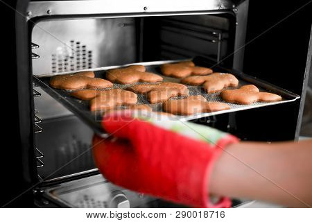 Ready Oatmeal Cookies On A Baking Sheet In The Oven. Baking On A Baking Sheet In The Hands Of The Co