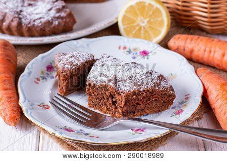 Chocolate Cake With Carrots In A Bowl On A White Wooden Table