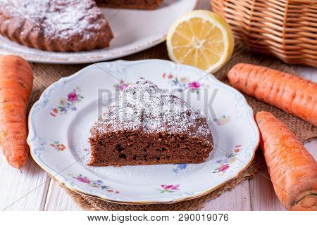 Chocolate Cake With Carrots In A Bowl On A White Wooden Table
