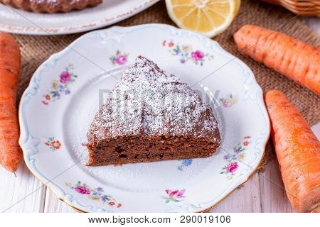 Chocolate Cake With Carrots In A Bowl On A White Wooden Table