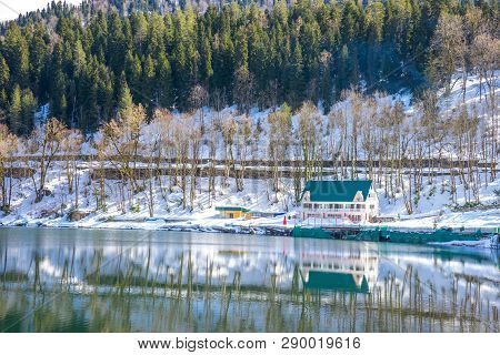A Beautiful House Is Displayed In The Waters Of A Mountain Lake.