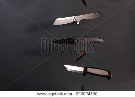 Three Different Knives In The Air. Knives Fly In Different Directions.
