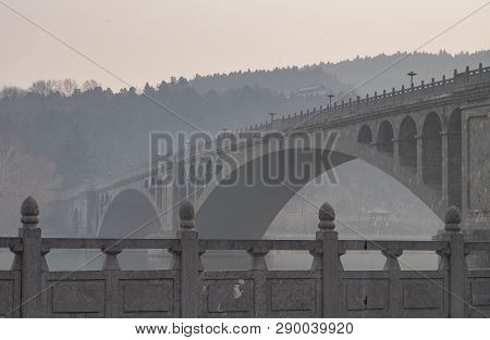 The Walk Way Along And The Bridge With The Chinese Style At The Longmen Grottoes. The Longmen Grotto