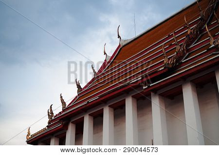 Fine-art Roof Top Of Main Chapel At Wat Kalayanamitr Temple On Cloudy Blue Background