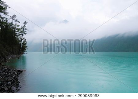 Turquoise Foggy Kucherla Mountain Lake. Belukha National Park, Altai Republic, Siberia, Russia