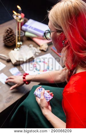 Top View Of Female Blonde Astrologist Sitting At The Table And Practicing
