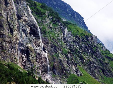 Waterfall Milchbachfall Or Wasserfall Milchbachfäll, Milchbäch Stream In The Alpine Valley Of Madera