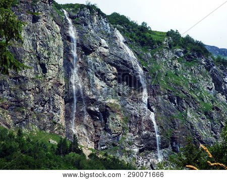 Waterfall Milchbachfall Or Wasserfall Milchbachfäll, Milchbäch Stream In The Alpine Valley Of Madera