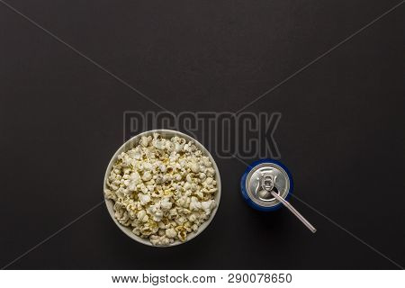 Bowl With Popcorn And A Can Of Drink On A Black Background. The Concept Of Watching Movies And Favor